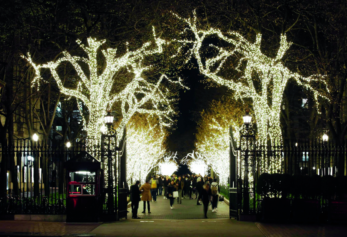 Amsterdam Avenue gate and college walk trees lit up with lights
