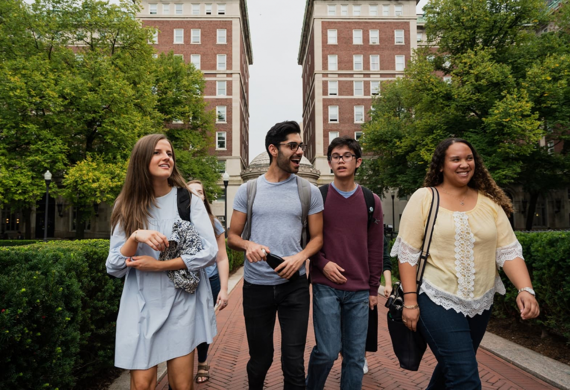 Four students walking on campus