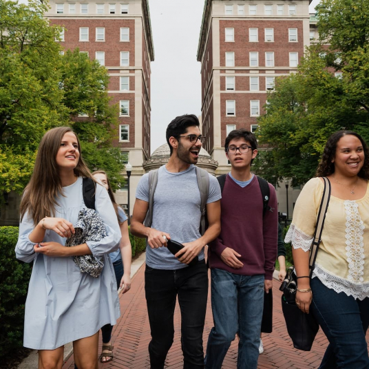 Four students walking on campus