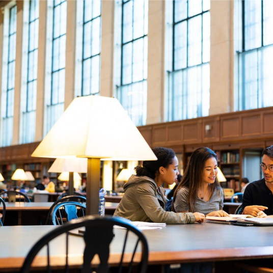 students sitting at a table in Butler Library