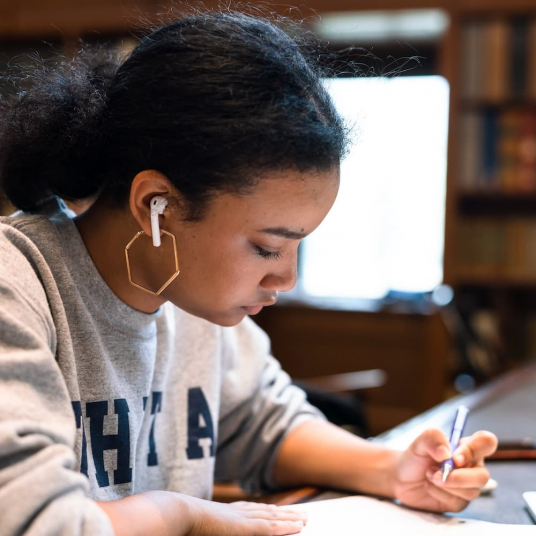 Student studying with headphones in the library