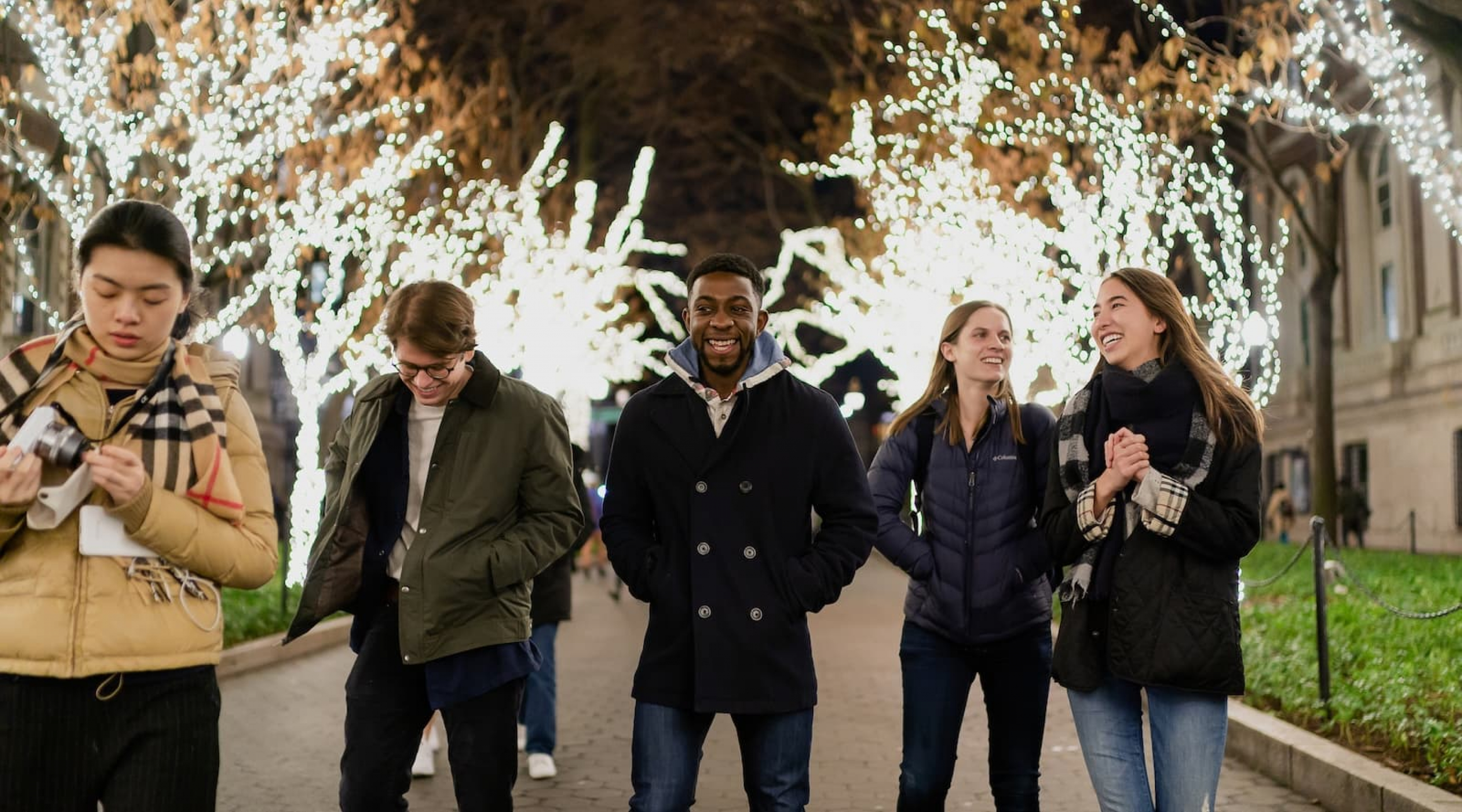 students walking on College Walk during Tree Lighting