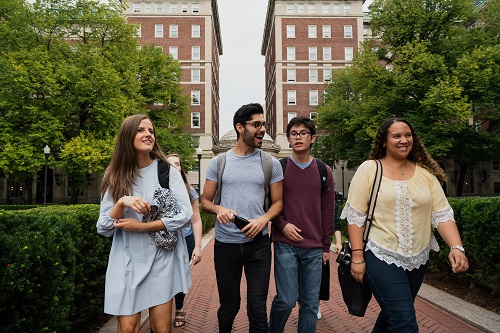 Four students walk together on Columbia's Morningside Heights campus.