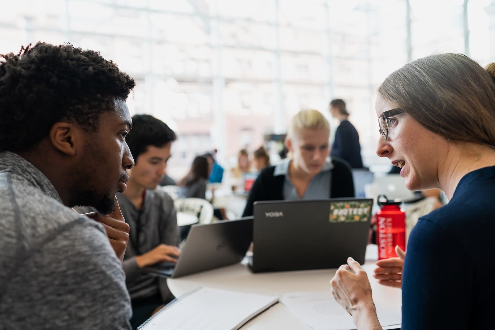 advisor speaks to students around a table