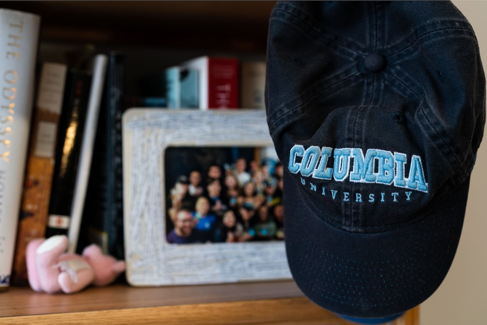 A navy Columbia baseball hat with books and a picture frame