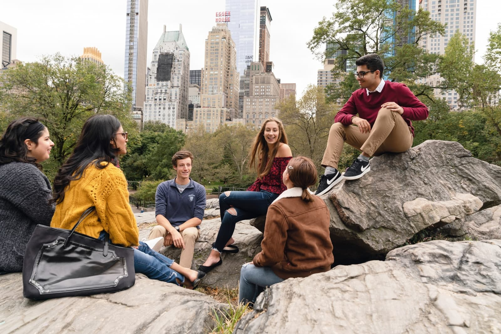 students sitting on a rock in Central Park