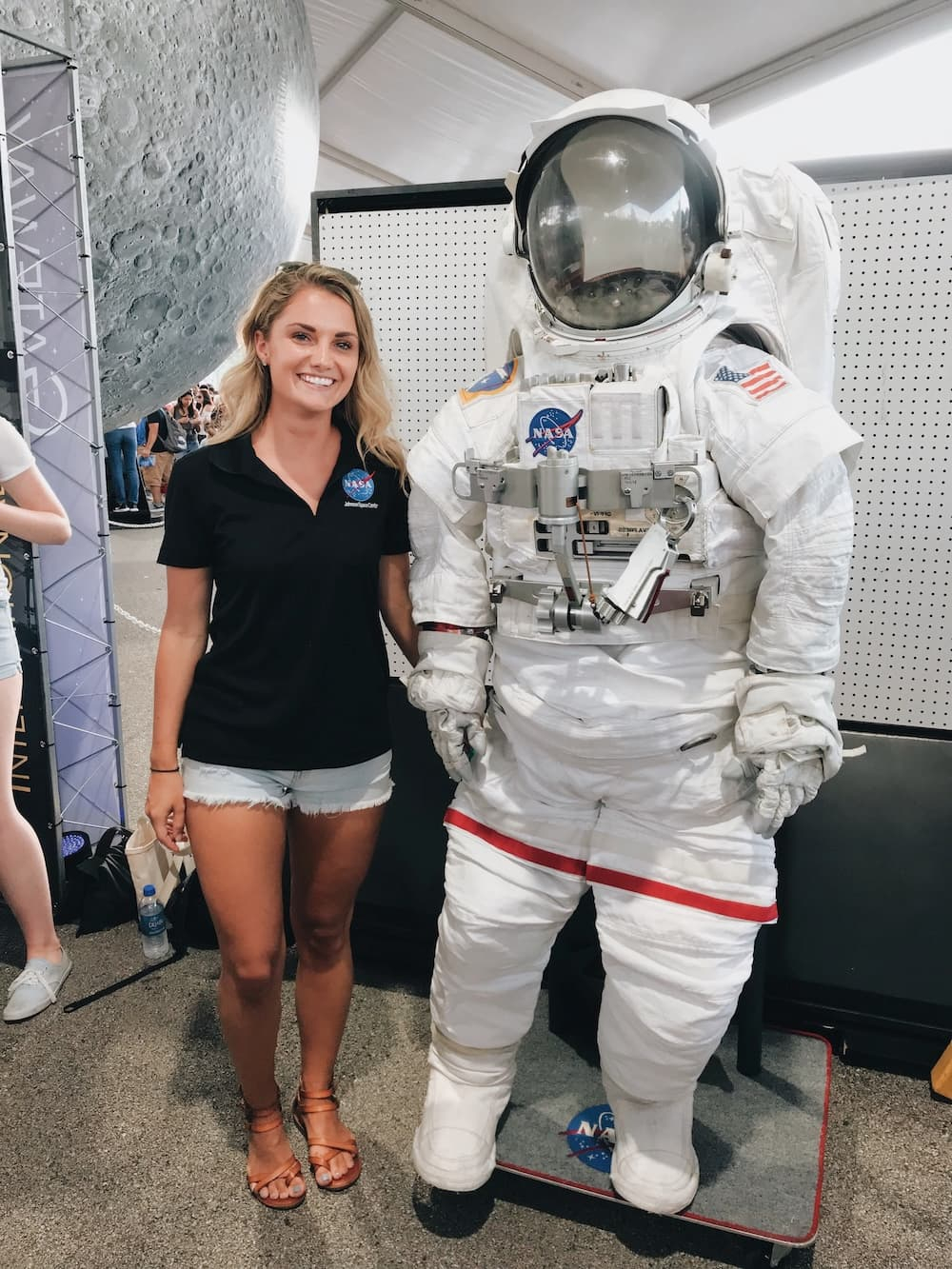 Student next to astronaut suit