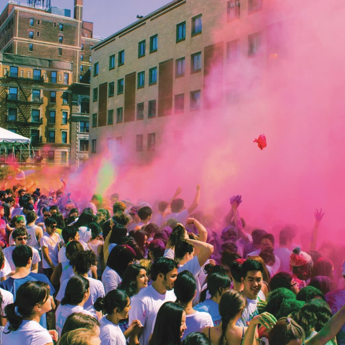 Students celebrating Holi by throwing colored powder on campus