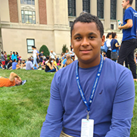 Columbia student Riley sitting on the lawn in front of Butler Library