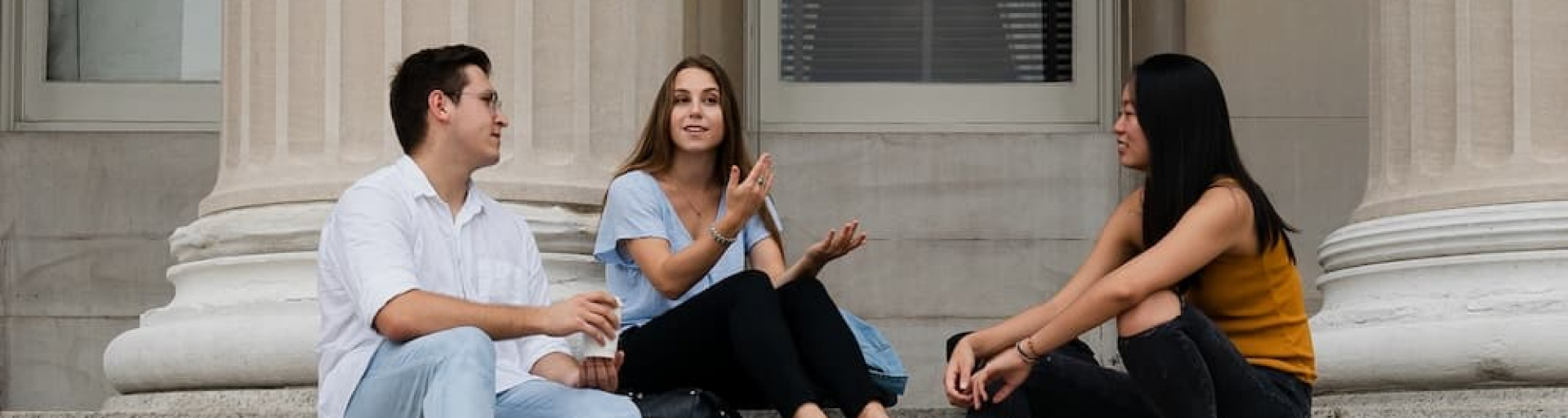 Three students sitting on the Low Steps