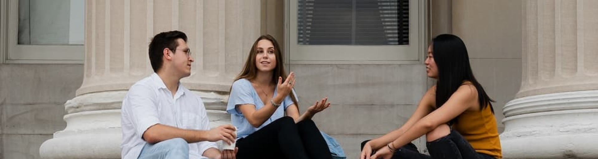 Three students sitting on the Low Steps