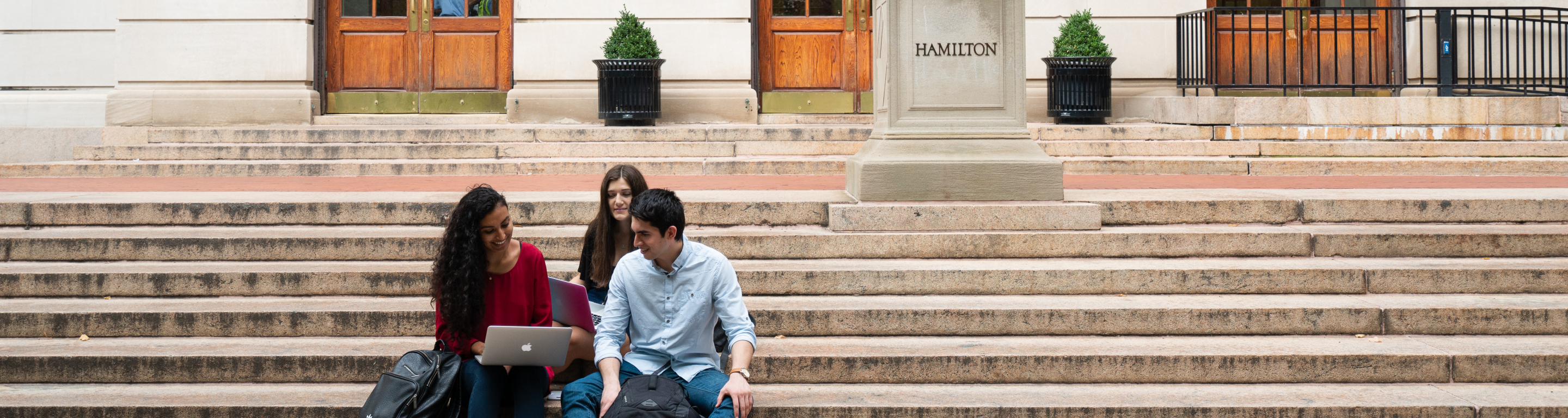 students sitting on hamilton hall steps