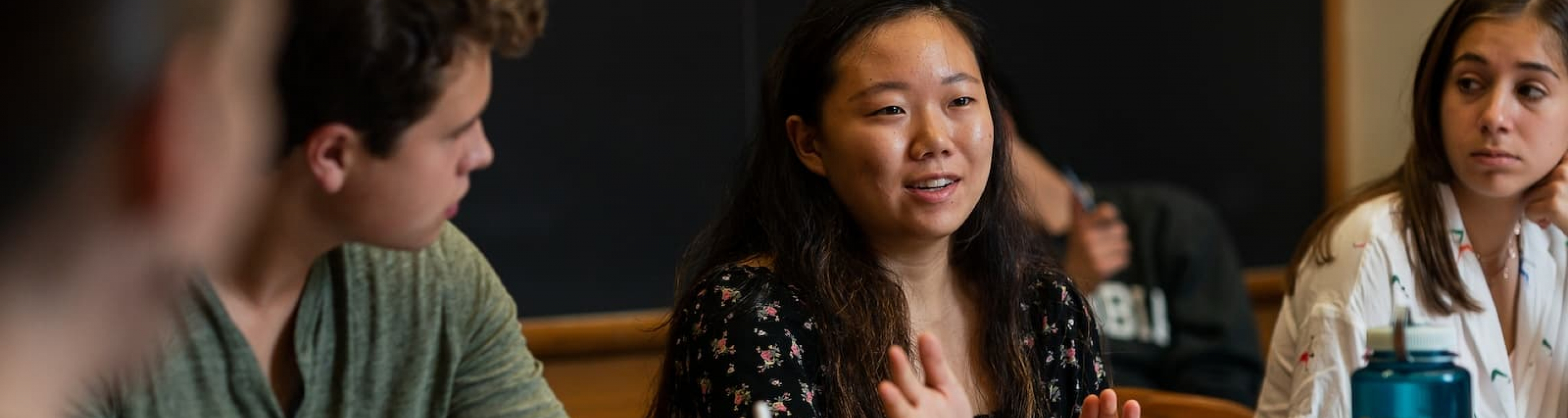 Columbia students sit around a classroom table during a seminar discussion