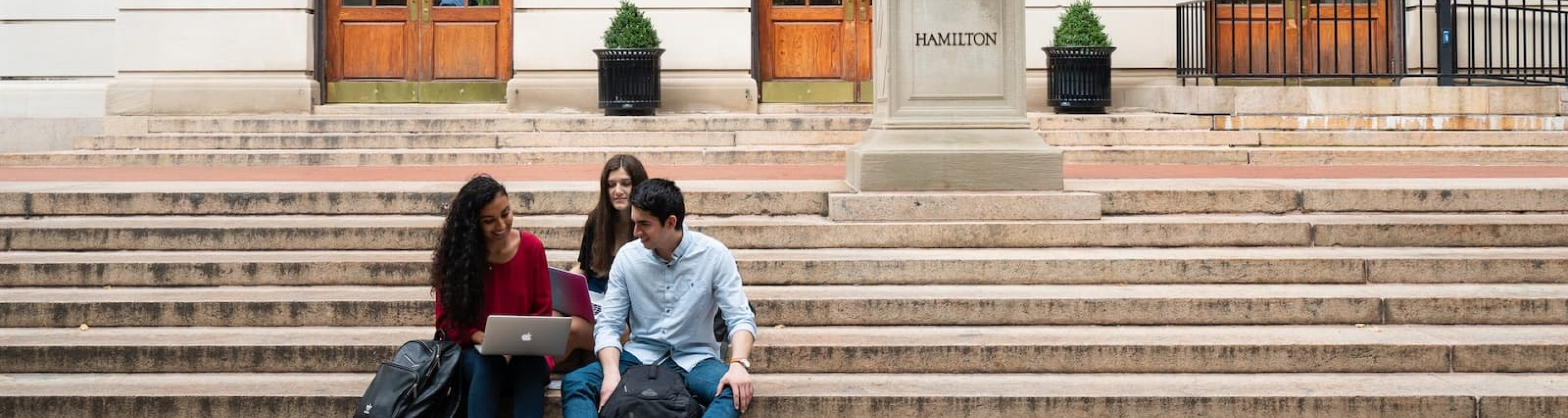 students sitting on Hamilton Hall steps
