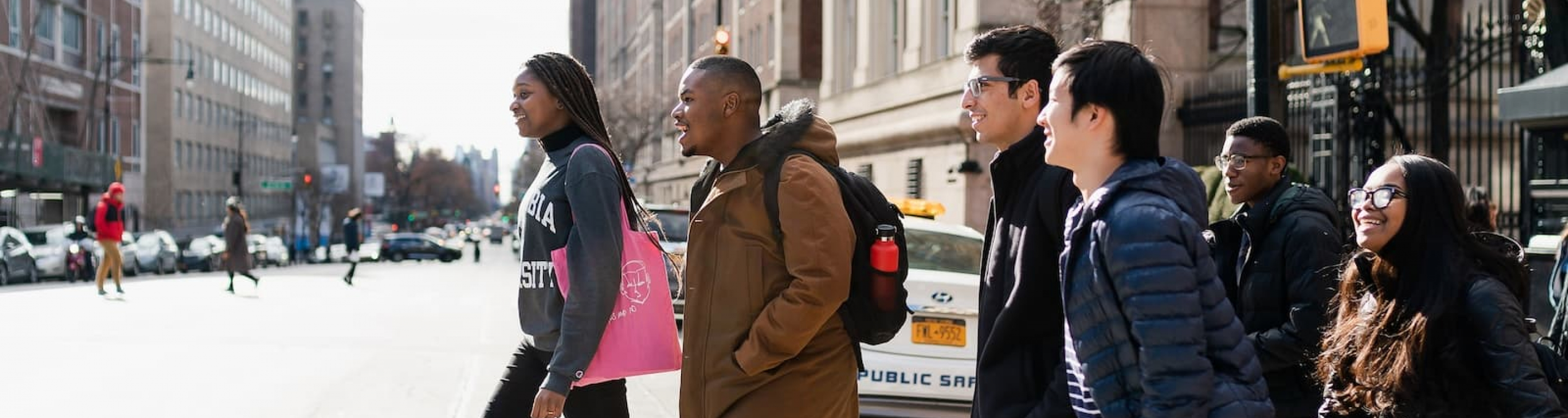 a group of students cross Amsterdam Avenue