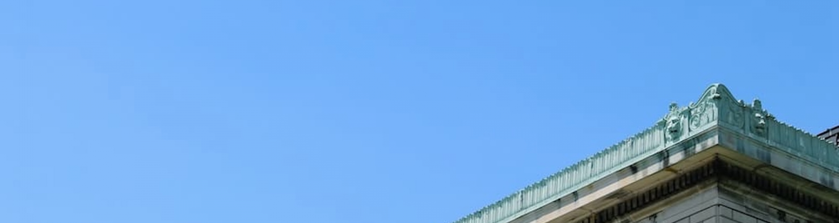 A blue banner with the Columbia crown on Pulitzer Hall
