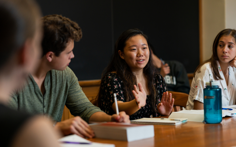 Columbia students sit around a classroom table during a seminar discussion