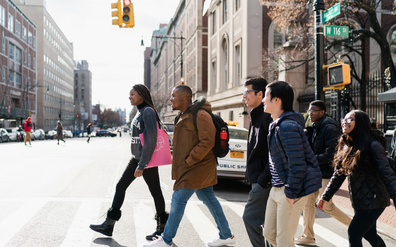 a group of students cross Amsterdam Avenue