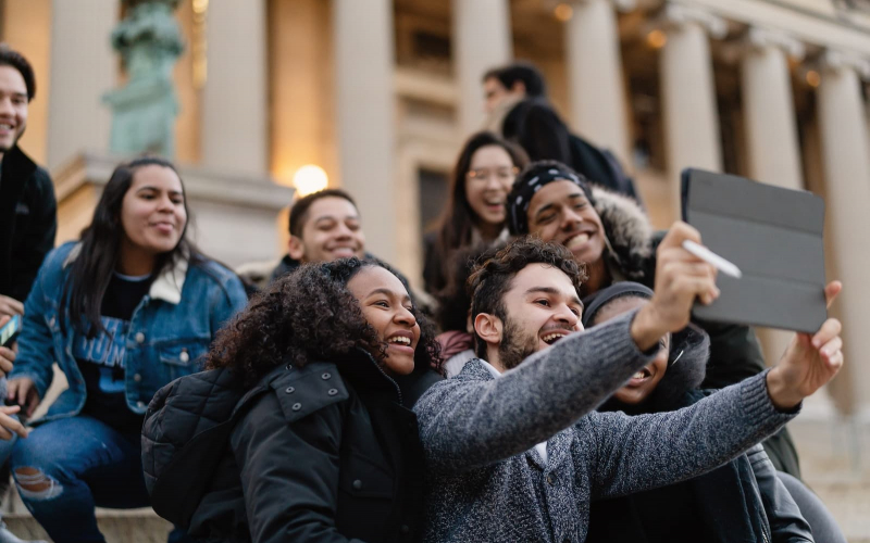 group of students video chatting outside